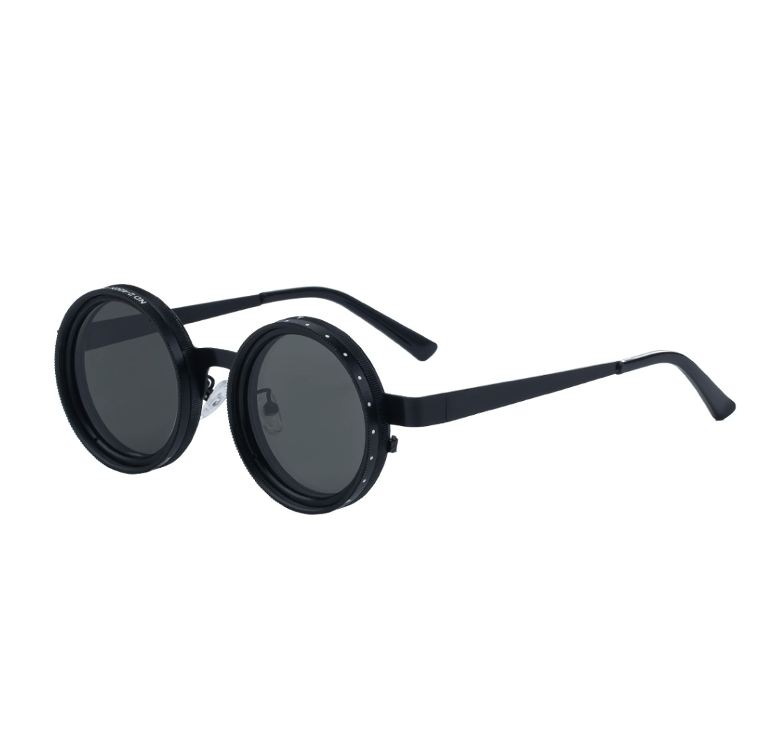 Matte black round sunglasses with decorative studded frames and dark lenses.