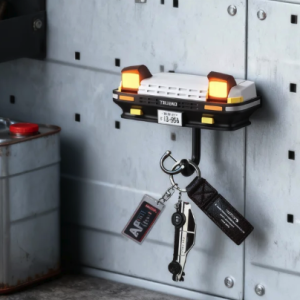 Initial D Toyota AE86 Trueno car front key holder on a garage pegboard with illuminated headlights.