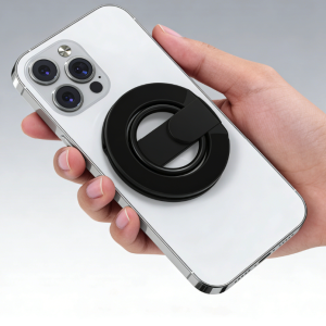 Hand holding white smartphone with black magnetic phone ring holder kickstand