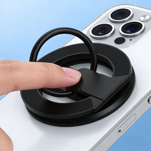 Black magnetic phone ring holder attached to a white iPhone, being adjusted by a finger.
