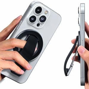Magnetic phone grip and kickstand accessory on a silver iPhone, demonstrating finger hold and stand function.